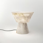 Lit noticeably brighter here, the Clérachic alabaster lamp sits on white with no cord in view.