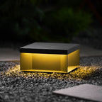 Black outdoor post light installed along a walkway