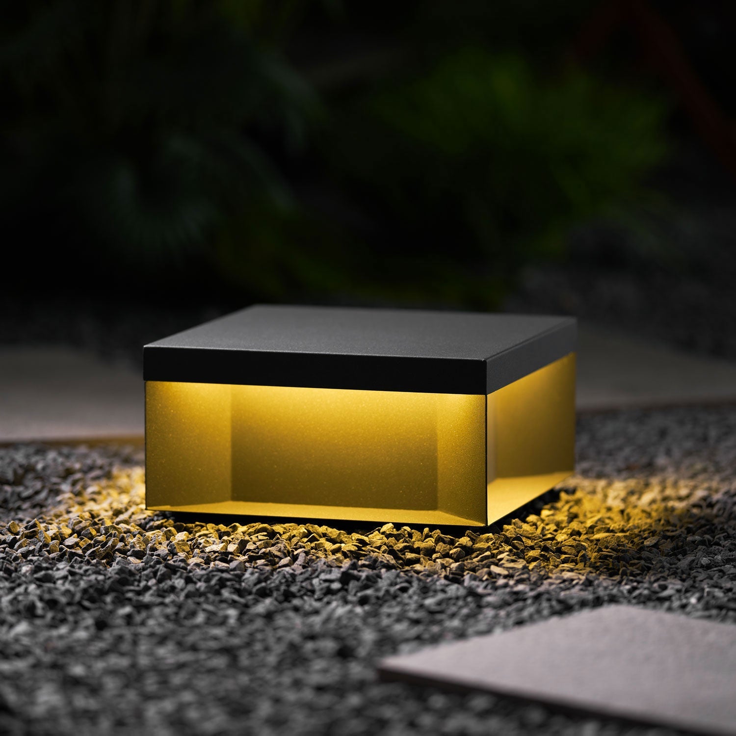 Black outdoor post light installed along a walkway