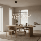 Black branch chandelier with delicate glowing tips lit warmly