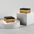 Square black post lamp lighting an outdoor walkway