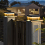 Square black post light illuminating an outdoor doorway