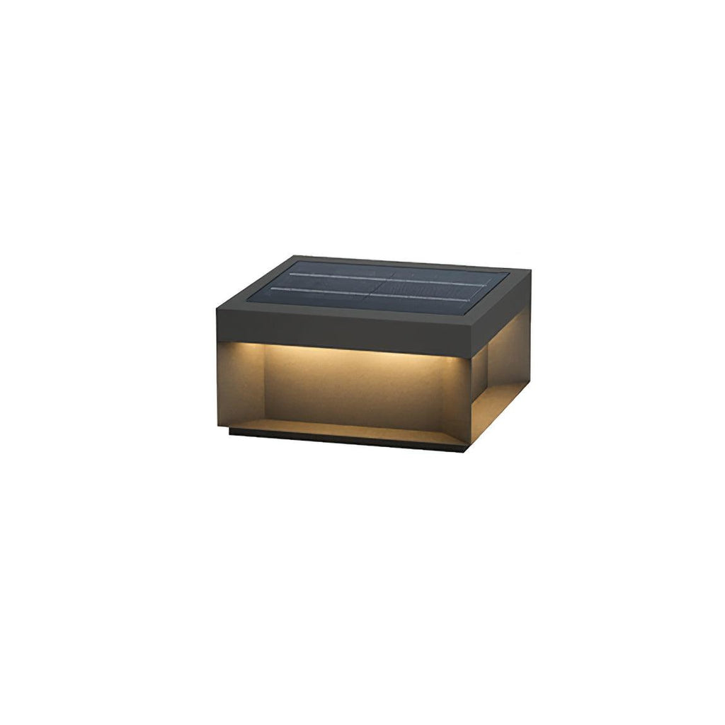 Black metal post light lighting a courtyard after dark