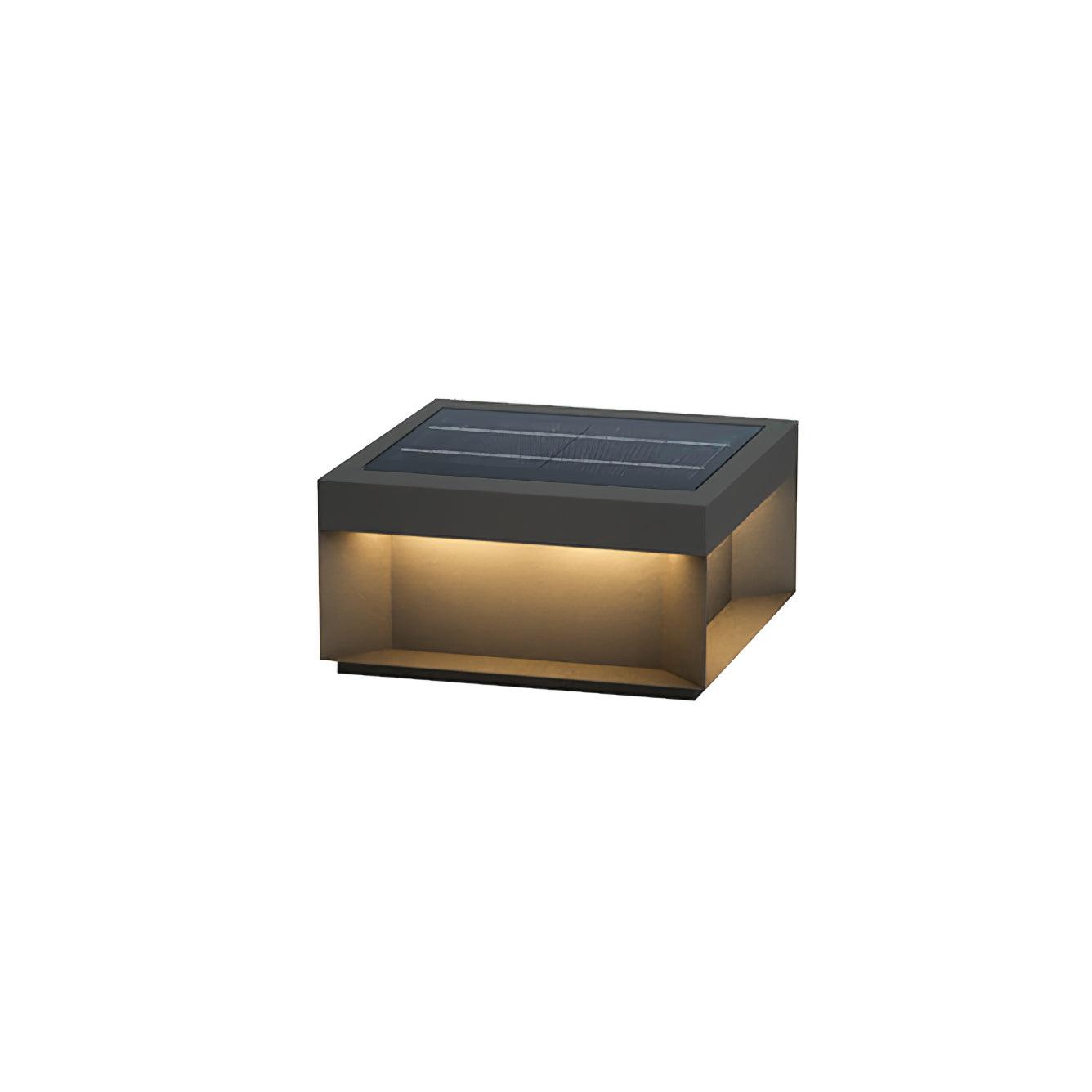 Black box post light casting warm light over a path