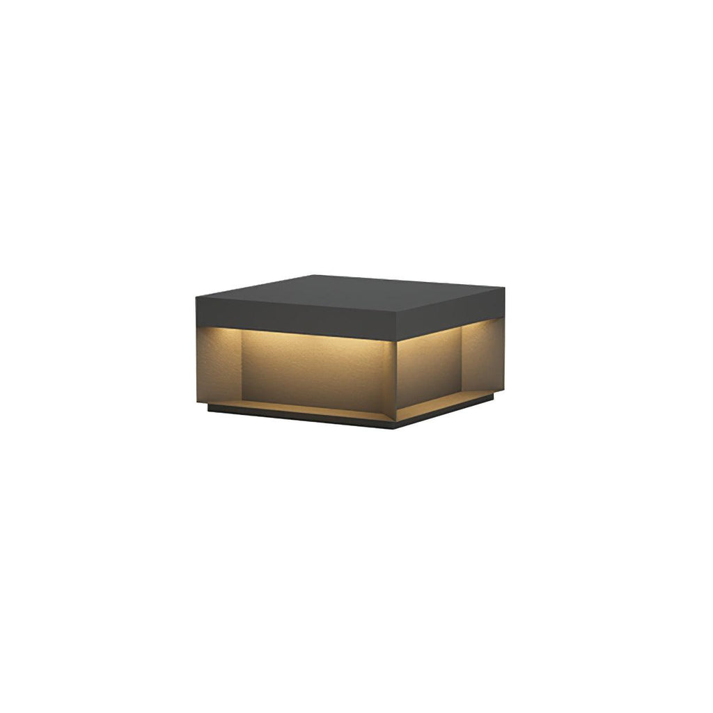 Black outdoor post light with frosted acrylic shade in a garden