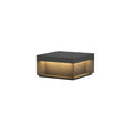 Black outdoor post light with frosted acrylic shade in a garden