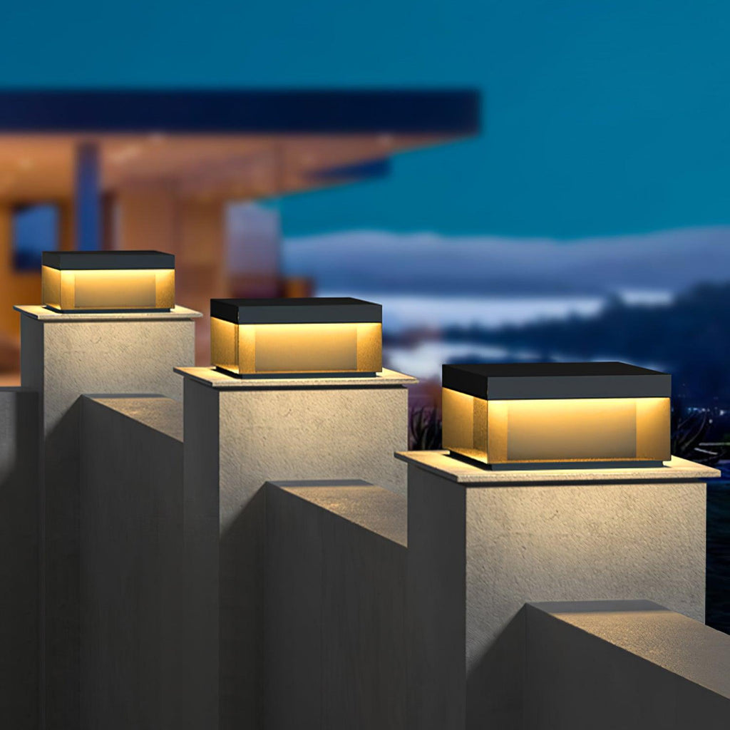 Sandblasted black outdoor post lamp glowing at night