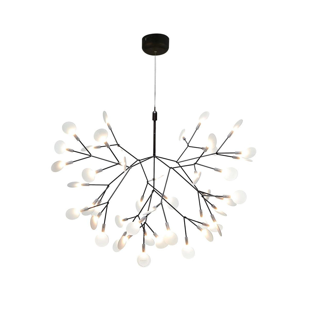 Black branch chandelier with firefly-like glowing tips over a table