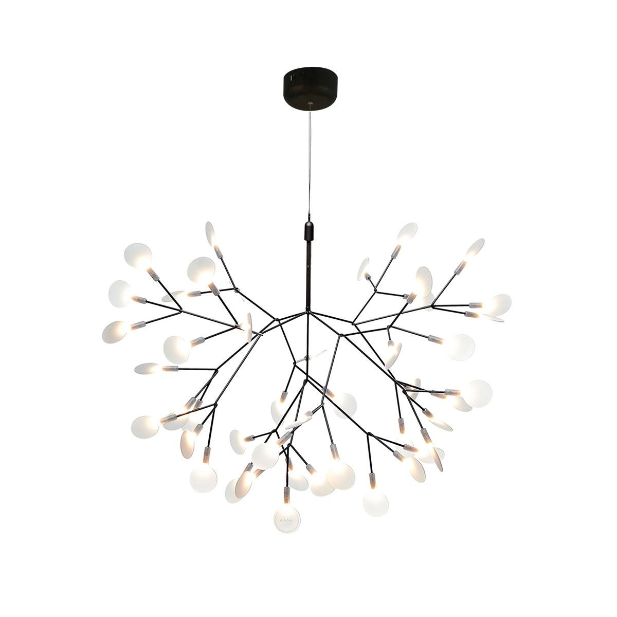 Black branch chandelier with firefly-like glowing tips over a table