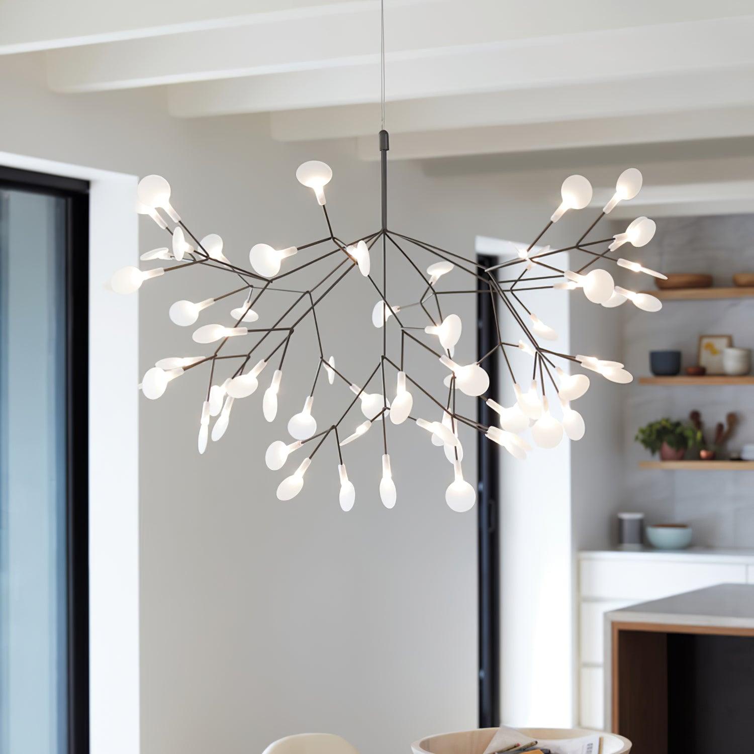 Black branch chandelier glowing above a seating area