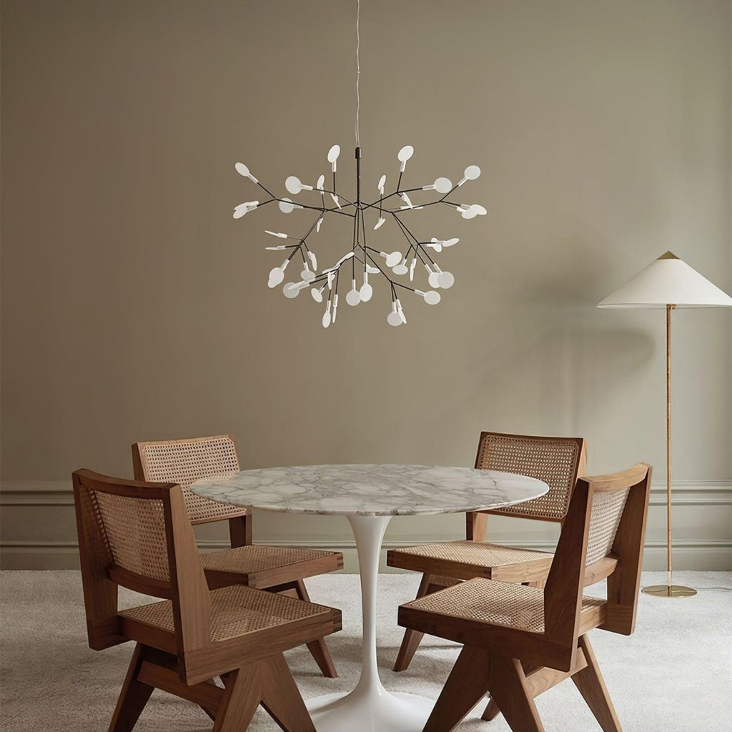 Black branch chandelier glowing gently above a living space