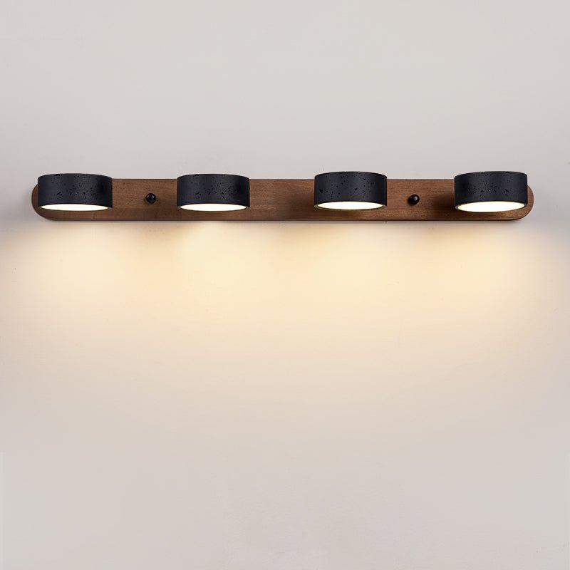 Black stone wall sconce mounted on a neutral wall