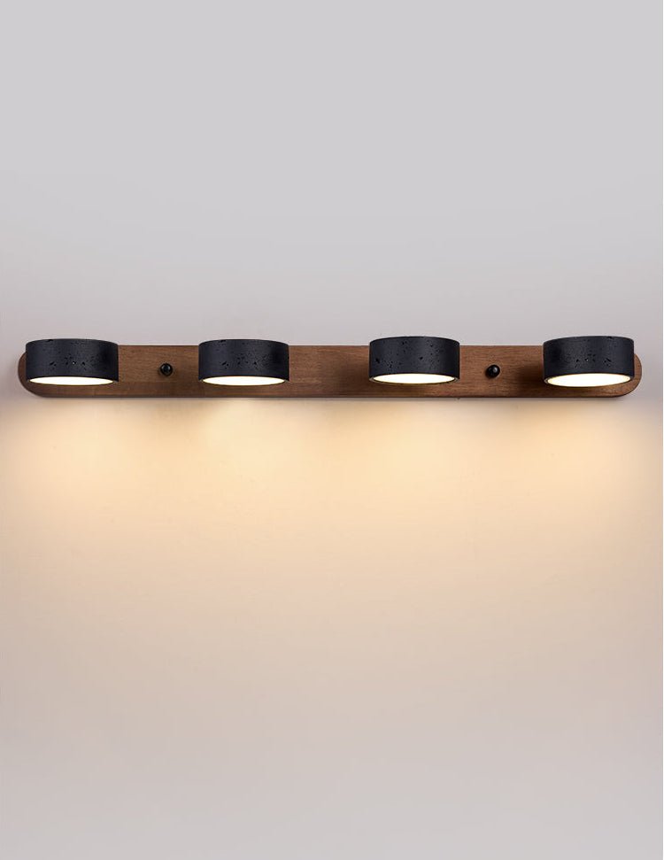 Travertine wall sconce mounted above a bedside table