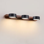 Travertine wall light casting soft glow beside a bed