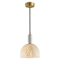 Clérachic alabaster pendant light against a plain white backdrop, the dome shade lit and the brass cord visible top to bottom.