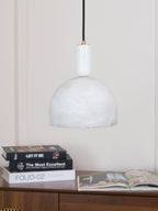 The same Clérachic dome sits unlit above a stack of books on a wooden sideboard, its veining visible in plain daylight.