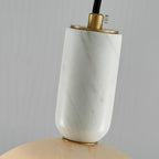 Macro shot of the Clérachic alabaster socket collar, showing where the brass fitting meets the veined stone neck.