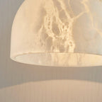Close-up of the Clérachic alabaster shade's underside from a wider angle, showing more of the interior curve and veining.