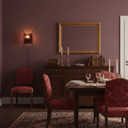 Brass wall light casting refracted red glow across a surface
