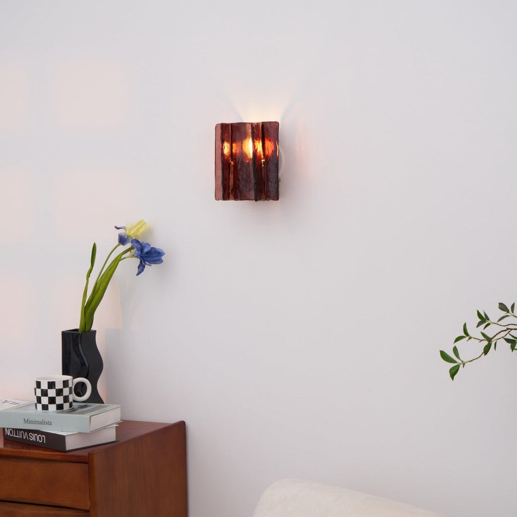 Gold brass wall sconce with geometric glass casting light patterns