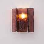 Brass wall sconce angled view with wine red glass accent