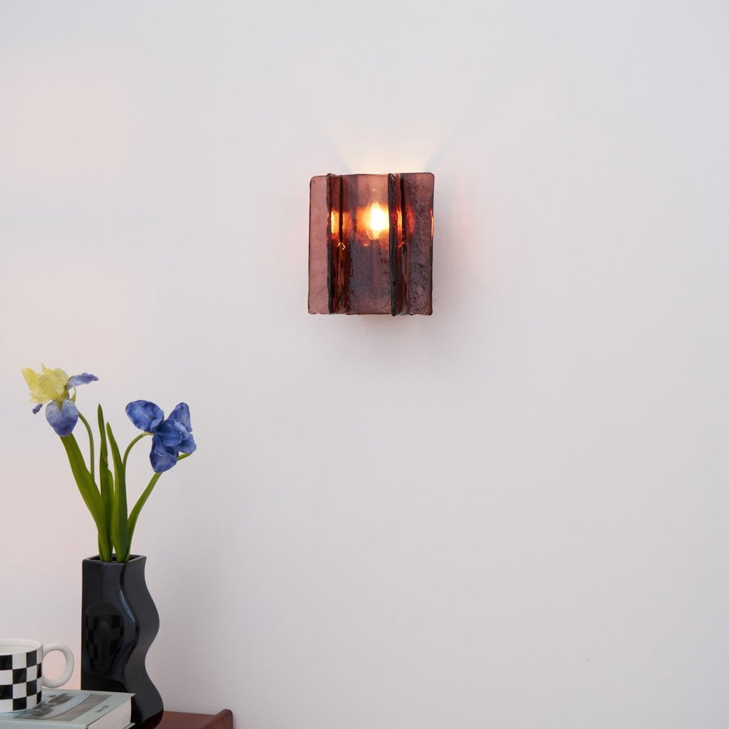 Brass wall sconce shown mounted near an entryway
