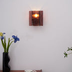 Gold brass wall sconce shown unlit on a neutral wall