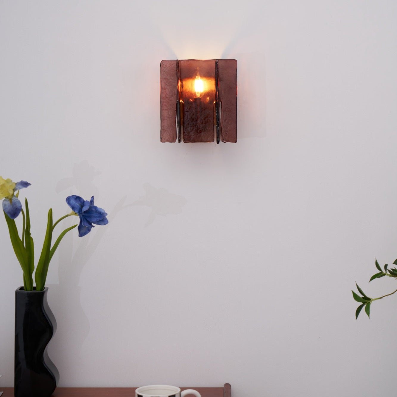 Gold brass wall sconce shown unlit on a neutral wall