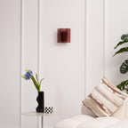 Detail of gold brass wall sconce and wine red glass element