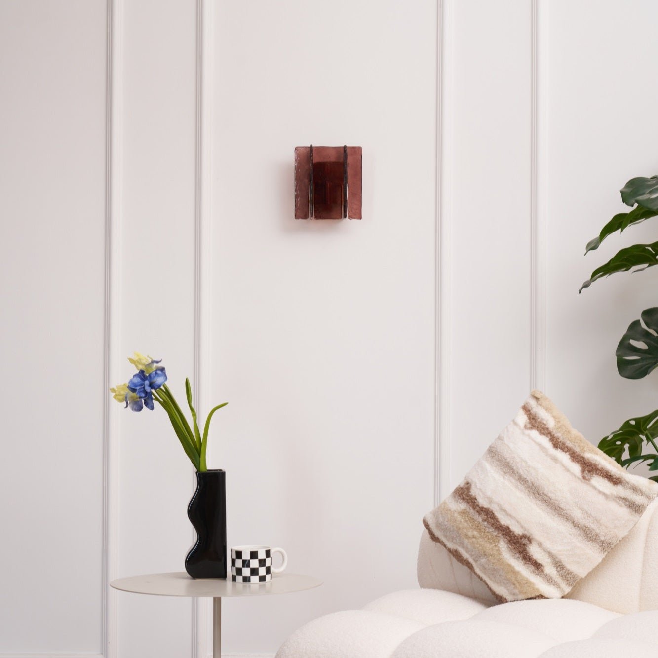 Detail of gold brass wall sconce and wine red glass element