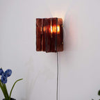 Brass and wine-red glass wall light styled in a modern space