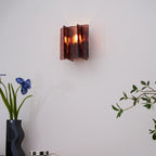 Brass wall sconce detail of gold frame and glass plates