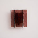 Brass wall sconce mounted on a wall in a styled interior