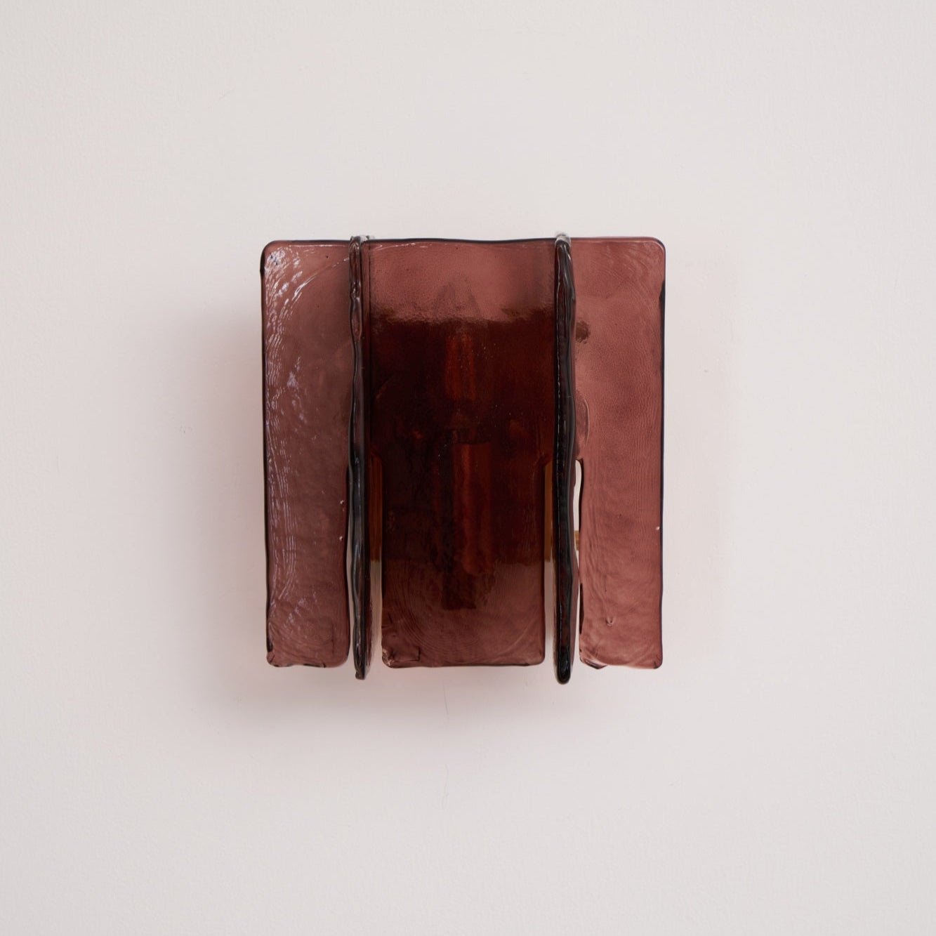 Brass wall sconce mounted on a wall in a styled interior