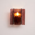 Brass wall sconce with wine red glass plates mounted on wall