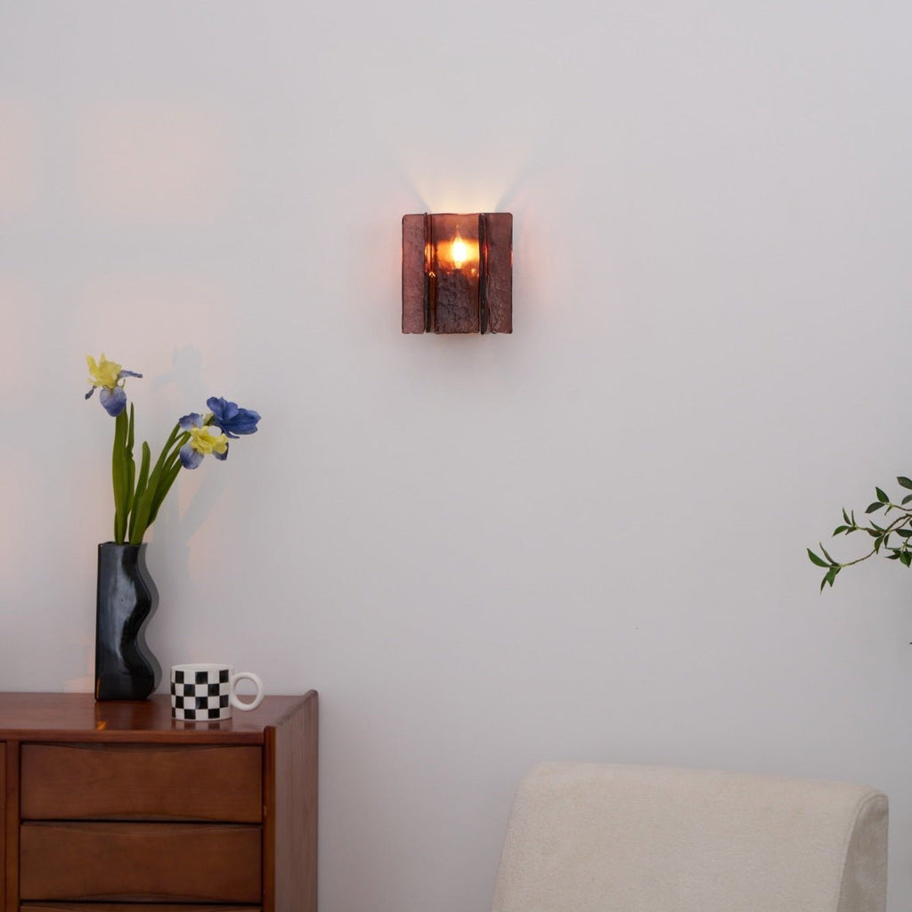Gold brass wall sconce casting layered geometric shadows