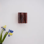 Brass wall sconce detail showing refracting clear glass plates