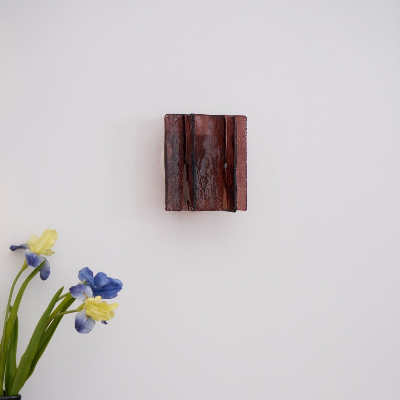 Brass wall sconce detail showing refracting clear glass plates