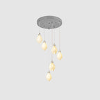 Cluster of white ceramic bloom pendant lights with brass arms