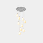 White ceramic bloom pendant lights suspended at varied heights