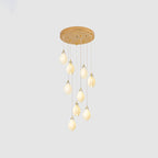 Ceramic flower pendant light arrangement glowing over an interior