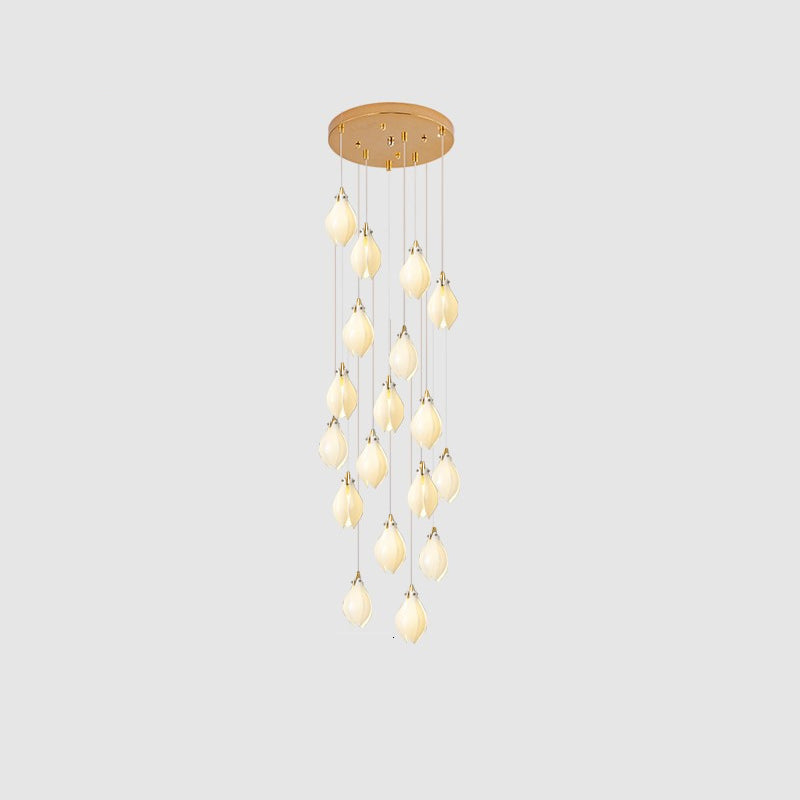 White ceramic bloom pendant light glowing against a neutral wall