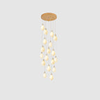 White ceramic bloom pendant light glowing against a neutral wall