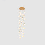 Multiple ceramic bloom pendant lights with warm interior glow