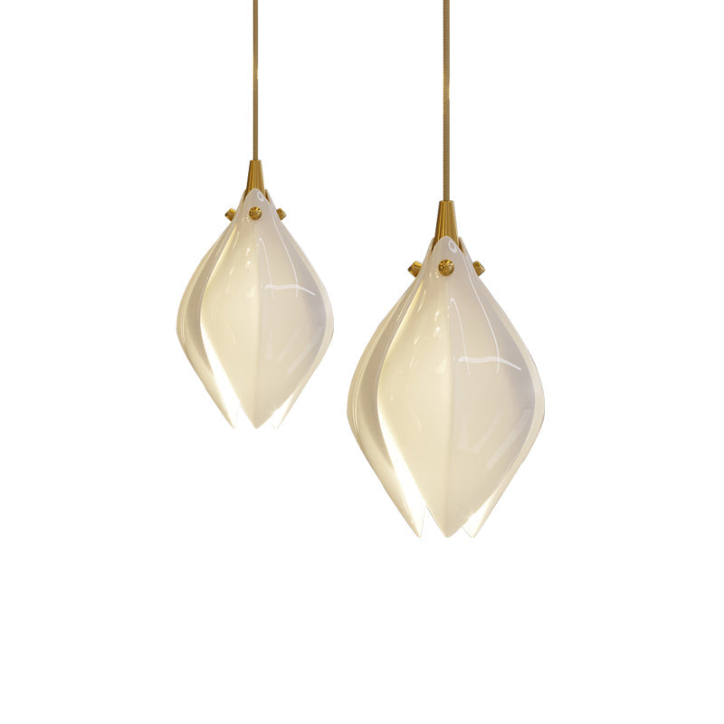 Ceramic flower pendant light with multiple lit blooms in a room