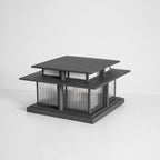 A front-on unlit view of this Clérachic pillar light against a grey backdrop, showing its dark aluminium frame.