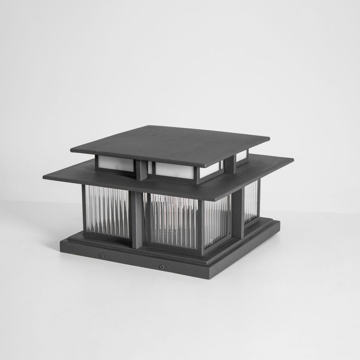 A front-on unlit view of this Clérachic pillar light against a grey backdrop, showing its dark aluminium frame.