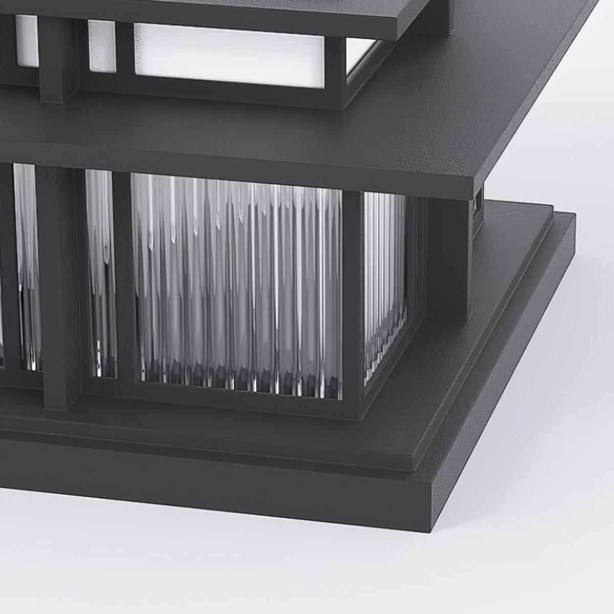 Close view of the fluted glass panel and sandblasted aluminium corner frame on this Clérachic pillar light.