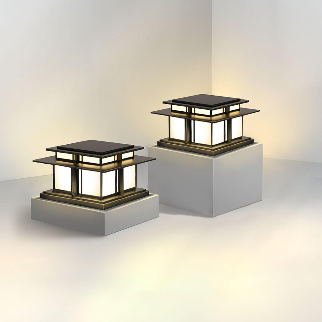 Two Clérachic pillar lights of different heights stand side by side on grey plinths, one fluted, one frosted glass.