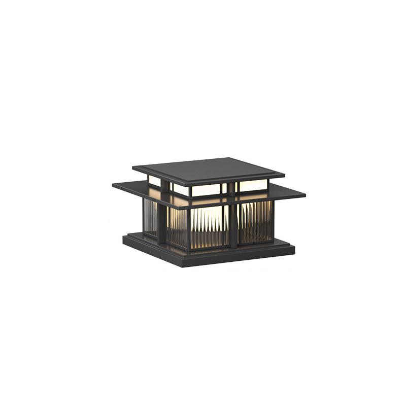 Unlit, this Clérachic pillar light shows its fluted glass panels and sandblasted aluminium frame on a plain backdrop.